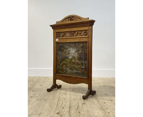 An Edwardian floral carved walnut fire screen, having a glazed oil on canvas panel depicting a romantic landscape, H89cm, W61