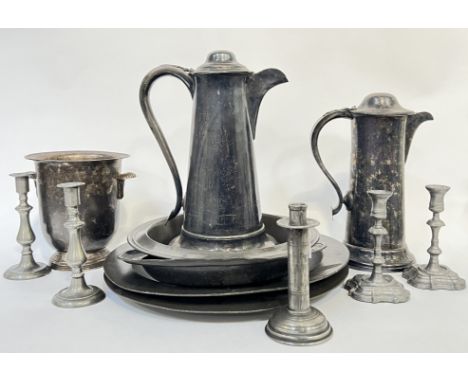 A group of pewter items comprising a Champagne bucket with scallop shell handles, four platters (largest w- 47cm), two lidded