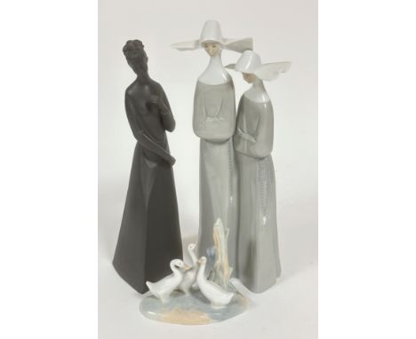 A Spanish Lladro figure group of Two Spanish Nuns (33cm x base: 13cm), a Royal Doulton Sympathy black basalt style figure (31