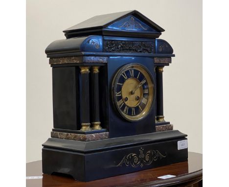 A Victorian slate mantel clock of Palladian form, with cast brass frieze, plain fluted columns on marble base, gilt and black