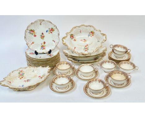 A Coalport Rococo style part desert service decorated with floral sprigs in polychrome enamels and gilding comprising six foo
