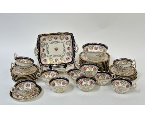 A Cauldon china rose and gilt foliage with blue enameling and gilt decoration part tea service comprising two serving dishes 