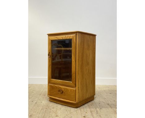 Ercol, a glazed blonde elm cabinet, the interior fitted with two shelves over a drawer H93cm, W56cm, D49cm