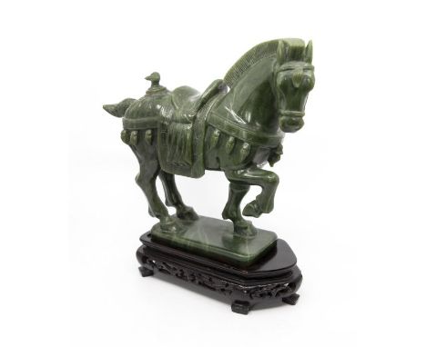 A Chinese green jade model of a Tang style caparisoned horse, 20th century, 25cm high, on pierced hardwood stand (1)