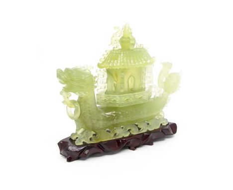 A jade dragon boat and cover with pierced scrolling base, 20th century, 20cm high, on hardwood stand (3) (slight damage, piec