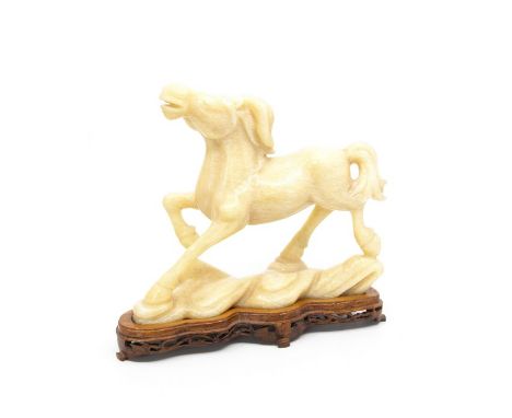 A Chinese white jade effect model of a galloping horse, 20th century high, on hardwood stand (1)