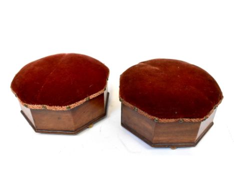 Two early 20th century mahogany octagonal wooden footstools with red velvet upholstered tops, raised on four brass ball feet,