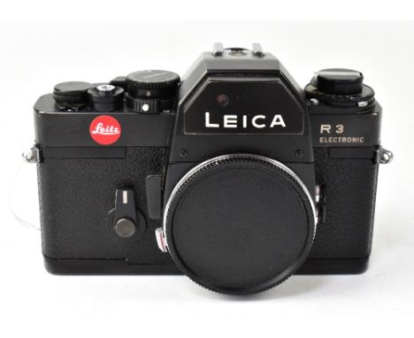 A Leica R3 electronic film camera body. CONDITION REPORT: The camera body is in good cosmetic condition with light surface sc