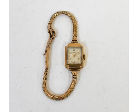 ROTARY; a ladies' vintage 9ct gold Art Deco style wristwatch, the rectangular white dial set with raised gold numeral increme