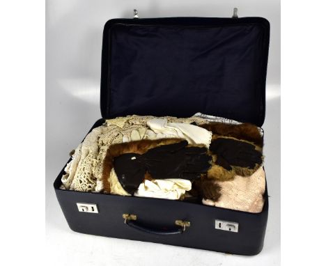 An early 20th century steamer trunk initialled 'EP', 49 x 92 x 45cm, containing various faux fur coats, two lambswool and lea