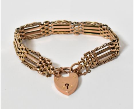 A 9ct yellow gold gate link bracelet with safety chain and heart-shaped padlock clasp, length approx 18cm, approx 21g.