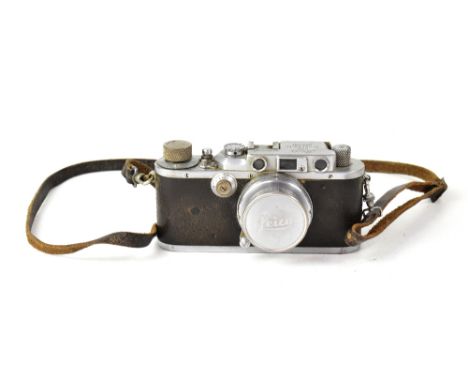 A 1938 Leica IIIA 30554, fitted with a 50mm I:2 Summar lens, leather strap and maker's lens cap.  CONDITION REPORT: The camer