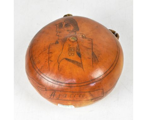 A 19th century Bugbear powder flask made from an exotic shell with floral decoration to one side and a portrait of Napoleon t