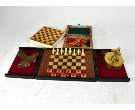 Three travelling chess sets, a spirit level with hinged cover, inscribed 'CSM', and a reproduction pocket compass.