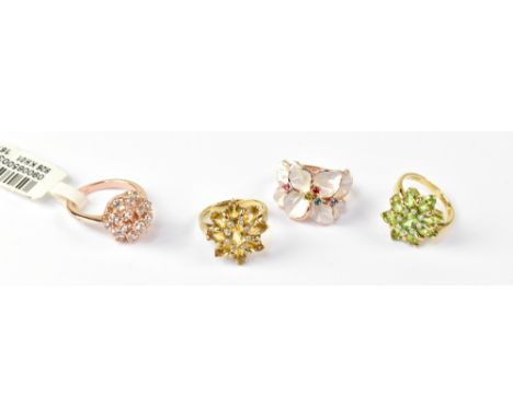 Two 9ct yellow gold floral dress rings, one with green citrine and small white diamonds, size J, the other with pale amber-co