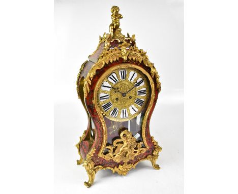 A late 19th/early 20th century boulle work mantel clock with ormolu inlay and scrolling decoration throughout the case, putto