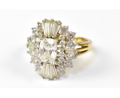 A 9ct yellow gold dress ring in the Art Deco style, set with central emerald cut white stone and baguette and round white sto