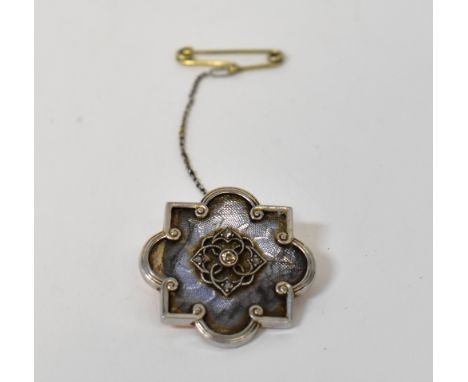 A late 19th/early 20th century diamond brooch, the central collet set diamond in a square filigree centre, with tiny diamond 
