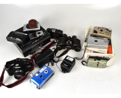 A collection of cameras to include a Canon Snappy EZ pint-and-shoot film camera, a Konica Minolta DiImage X1, a pair of Telst