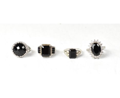 Four sterling silver and black spinel dress rings, comprising a large trellis set facet cut Vietnamese black spinel, approx 1