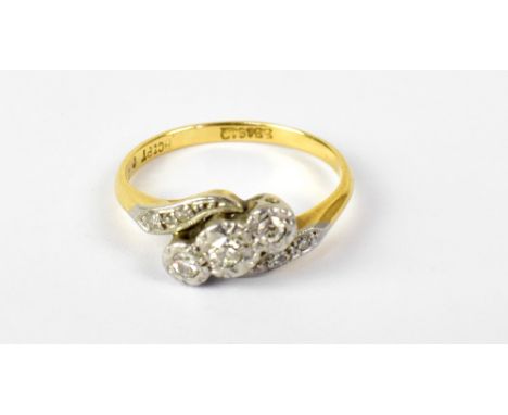 An 18ct yellow gold ring with three illusion set diamonds on a twist, set in platinum, size K, approx 3.1g.