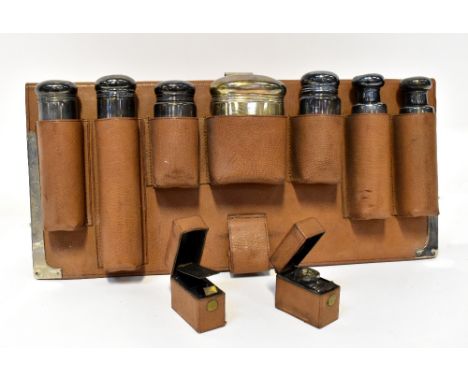 FINNIGANS LTD; an Edwardian hallmarked silver seven-piece lidded toiletry set in leather fitted suitcase insert, 91 x 41cm, t