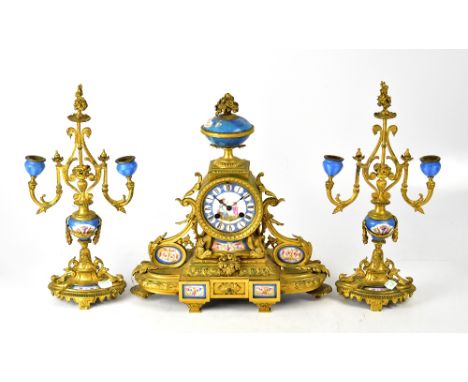 A 19th century gilt brass clock garniture with floral decoration on a blue ground, the dial centred with a young lady and a c