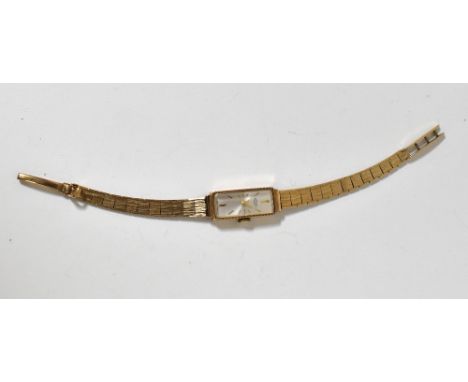 ROTARY; a ladies' vintage 9ct gold wristwatch, the rectangular silvered dial set with cut gold line increments, crown wind mo