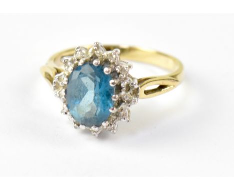 A 9ct yellow gold dress ring with central oval facet cut aquamarine-coloured stone, size K, approx 2.3g. 