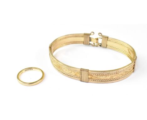A 9ct gold wedding band, approx 2g, and a yellow metal bangle (2).