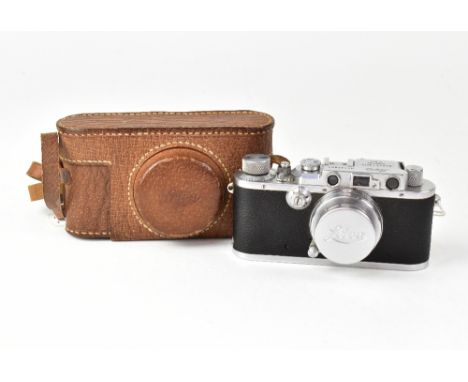 A 1934 Leica III camera serial no.133851, fitted with a 50mm 1:2 Summar lens, leather Leica case and maker's lens cap. CONDIT