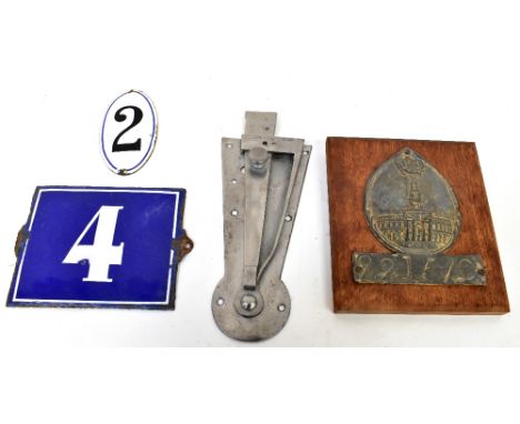 An early 19th century lead embossed plaque for the Royal Exchange Assurance, on later plinth, two enamelled door number signs