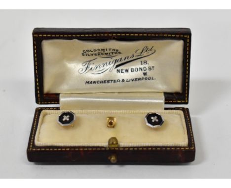 A pair of 18ct gold and black enamel collar studs, in presentation box. CONDITION REPORT: The screw in front on one appears t