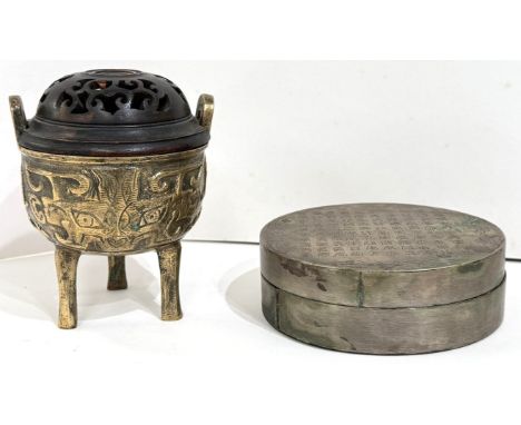 A small brass Chinese tripod censor with pierced domed wooden top, overall height 12.5cm; a circular metal covered box with t