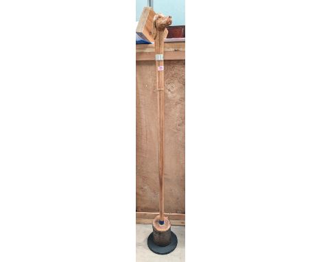An unusual carved wooden staff with dogs head finial and silver collar