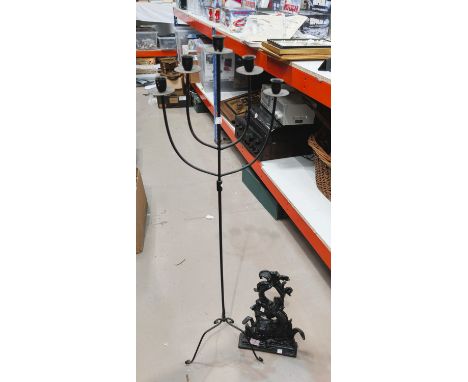 A cast iron Victorian door stop; a wrought metal five-sconce floor standing candelabra.