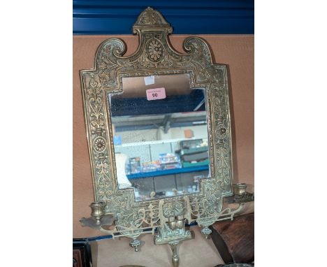 A Victorian brass wall mirror with twin side sconces; a n adjustable brass standard lamp with Tiffany shade (shade a/f).Brass