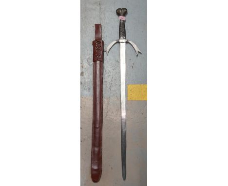 A reenactment/ model of a viking sword with leather scabbard