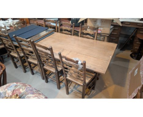 A large distressed oak dining suite in the manner of Titchmarsh &amp; Goodwin comprising refectory table, length 240cm with 8