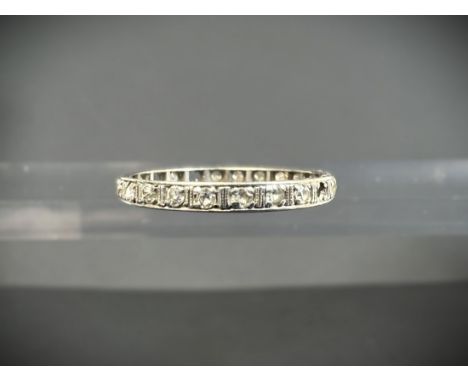A white metal full eternity ring set with small diamonds (3 stones missing) 2.24gm, size R