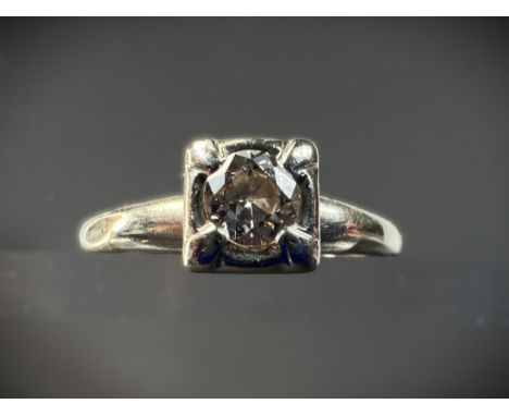 A white metal dress ring set with circular solitaire diamond in square setting, shank stamped 14k, size R, 3.21gms, diamond a