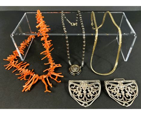 A vintage graduating red coral necklace; a Hematite bead a gilt necklace with faux coin pendant, a 'nurses' buckle and a gilt