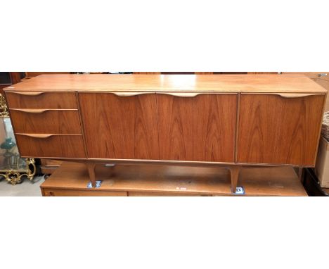 A mid-20th century McIntosh Dunvegan teak sideboard with central two-door cupboard with shaped interior shelf, single-door dr