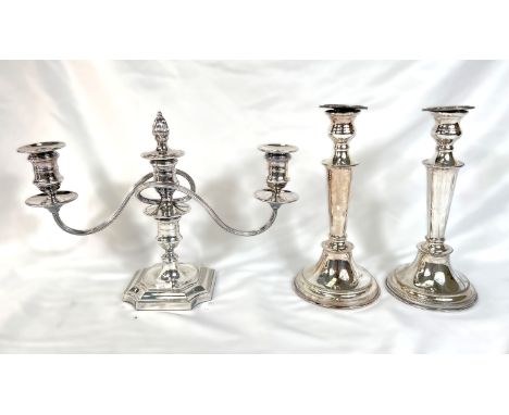 A three-branch silver-plated candelabra and pair of candlesticks.