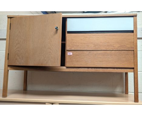 A 1970's G Plan light oak and white laminate two piece bedroom suite comprising kneehole dressing table and side cabinet