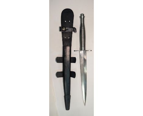 A post WWII Fairbairn Sykes fighting knife in scabbard