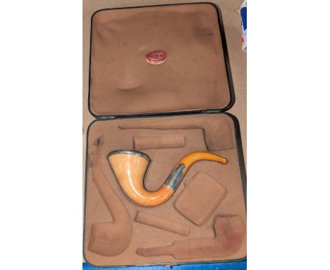 An originally boxed Meerschaum drop-chin pipe with silver mounts.