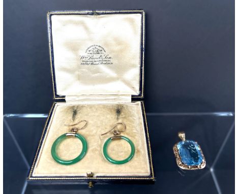 A yellow metal pendant set with rectangular clear blue stone; a pair of clear jade coloured green hoop earrings with yellow m