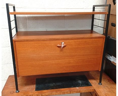 A half-height Ladderax wall unit with shelf and lockable fall-front cupboard with shaped interior shelves.