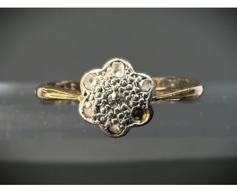 An 18ct hallmarked yellow metal and platinum ring with flower shaped top set with small diamonds (1 missing) size R/S, 2.69gm